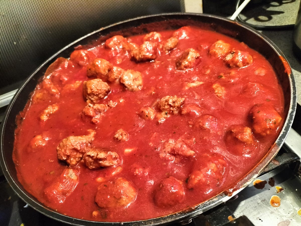 Nonna's spaghetti and meatballs cooking in the pan